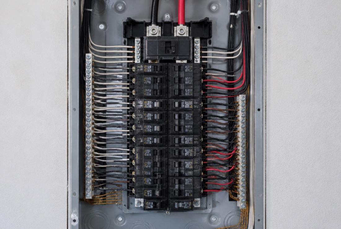 Open residential electrical breaker panel checked for EV charger capacity